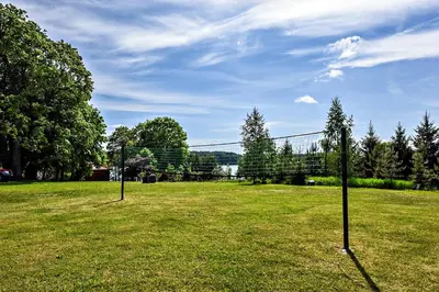 two goal posts in a field with trees and a sky at Mekų sodyba in Degučiai