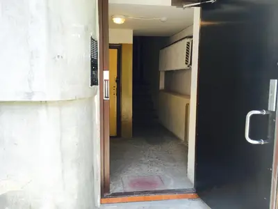 a hallway with a door open to a hallway with stairs at Apartment Vilnius Zemaitijos in Vilnius