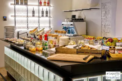 a kitchen counter with a bunch of food on it at Artagonist Art Hotel in Vilnius