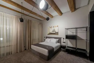 a bedroom with a bed and a television in it at Artagonist Art Hotel in Vilnius
