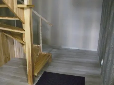 a staircase in a room with wooden floors at Centro bustas in Kėdainiai