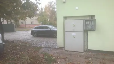 a car parked in a parking lot next to a building at Centro bustas in Kėdainiai