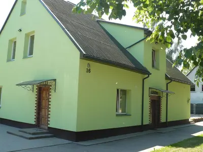 a yellow and white house with a black roof at Centro bustas in Kėdainiai