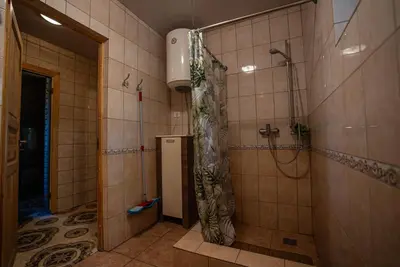 a bathroom with a shower with a shower curtain at Namelis su pirtele in Druskininkai