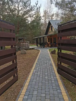 a brick walkway in front of a house at Namelis su pirtele in Druskininkai