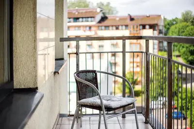 a chair sitting on top of a balcony at Zalgirio apartment in Vilnius