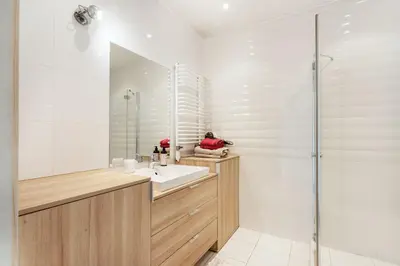 a bathroom with a sink and a shower at Zalgirio apartment in Vilnius