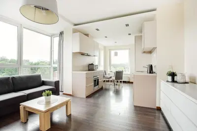 a living room with a couch and a table at Zalgirio apartment in Vilnius