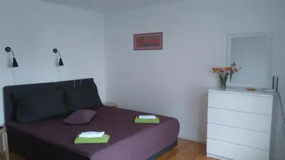 a bedroom with a bed with two towels on it at Apartamentai Tarp trijų ežerų in Tytuvėnai