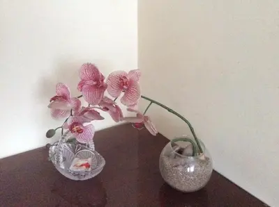 two pink flowers in a vase on a table at Kotedžai Milikonių g. in Kaunas
