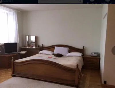 a bedroom with a wooden bed with two pillows at Kotedžai Milikonių g. in Kaunas