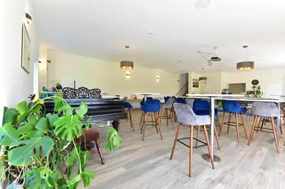 a living room with blue chairs and a table at Auroradream in Motiejiškės