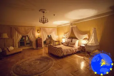 a large bedroom with a bed and a chandelier at Pakruojis Manor's Palace Boutique Hotel in Pakruojis