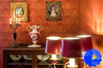 a room with a table with two lamps and a vase at Pakruojis Manor's Palace Boutique Hotel in Pakruojis
