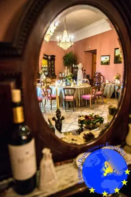 a reflection of a dining room in a mirror at Pakruojis Manor's Palace Boutique Hotel in Pakruojis