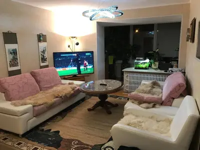 a living room with two couches and a tv at VIsagino Apartment in Visaginas
