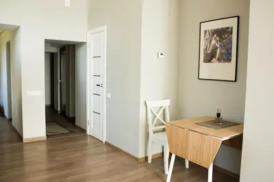 a dining room with a table and a chair at Owl Apartments in Kaunas