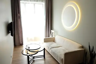 a living room with a couch and a table at Owl Apartments in Kaunas