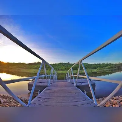 a wooden bridge over a body of water at Kambarių nuoma Kačerginės kurorte in Kačerginė