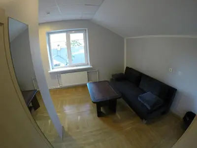 a living room with a couch and a table at Kambarių nuoma Kačerginės kurorte in Kačerginė