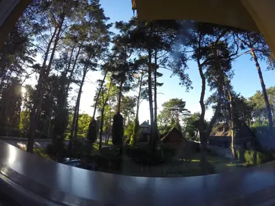 a view of a window with trees and a house at Kambarių nuoma Kačerginės kurorte in Kačerginė