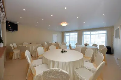 a room with white tables and chairs and a room with tables and chairs at MS Resort in Nemėžis