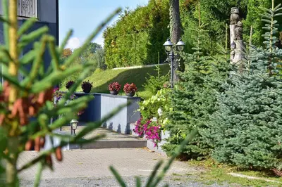 a garden with plants and flowers on a sidewalk at MS Resort in Nemėžis