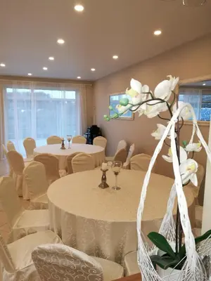 a meeting room with tables and chairs and a flower at MS Resort in Nemėžis