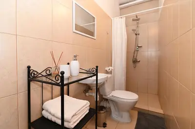 a bathroom with a toilet and a sink and a shower at MS Resort in Nemėžis