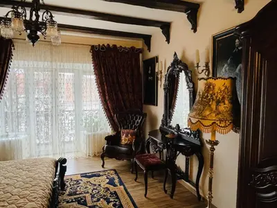 a bedroom with a bed and a chair and a mirror at Grand Duke Apartments in Vilnius