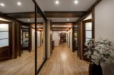 a hallway with a mirror and flowers in a vase at Grand Duke Apartments in Vilnius