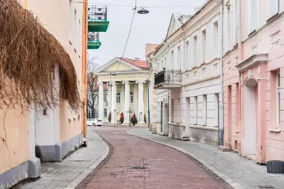 an empty street in a city with buildings at Grand Duke Apartments in Vilnius