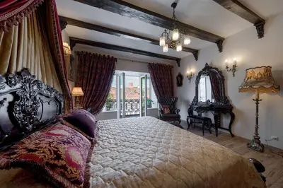 a bedroom with a large bed and a window at Grand Duke Apartments in Vilnius