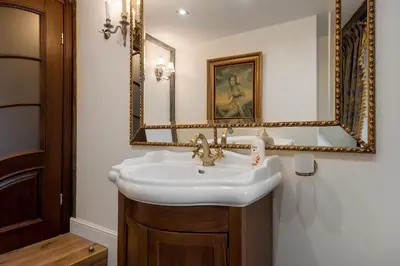 a bathroom with a sink and a mirror at Grand Duke Apartments in Vilnius