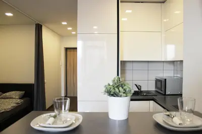 a kitchen with a table with two plates on it at New Studio In Oslo Namai in Vilnius