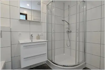 a white bathroom with a shower and a sink at New Studio In Oslo Namai in Vilnius