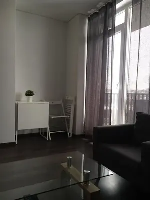 a living room with a couch and a table at New Studio In Oslo Namai in Vilnius