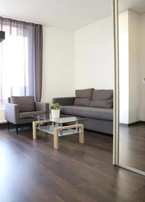 a living room with a couch and a table at New Studio In Oslo Namai in Vilnius