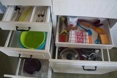 an open kitchen drawer with dishes and utensils at Guest House Mr Fox in Druskininkai