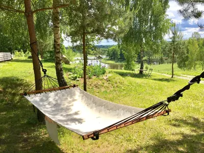 a hammock hanging from a tree in a park at Namelis šalia vynuogyno in Būdziliai