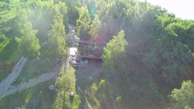 an aerial view of a train traveling through a forest at Namelis šalia vynuogyno in Būdziliai