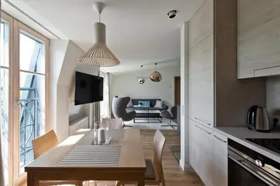 a kitchen and dining room with a table and chairs at Aura apartamentai in Druskininkai