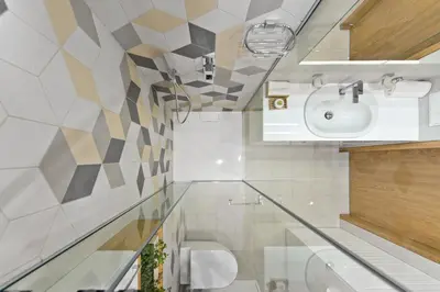 a bathroom with a sink and a toilet at Aura apartamentai in Druskininkai