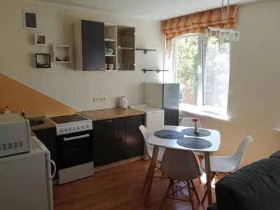 a small kitchen with a table and chairs in a room at Apartment for rent Druskininkai in Druskininkai