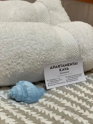 a blue toy fish sitting next to a pile of towels at Apartamentai KAVA in Zarasai