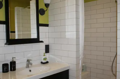 a white bathroom with a sink and a mirror at Luxury Apartment in Druskininkai
