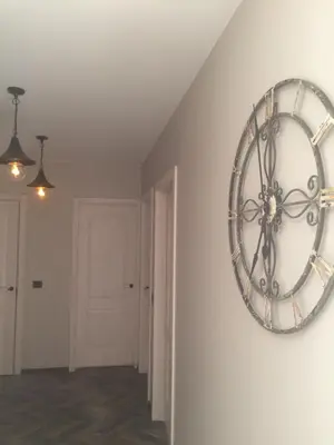 a large clock on a wall in a room at Luxury Apartment in Druskininkai