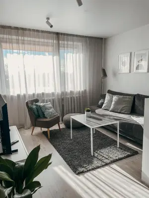 a living room with a bed and a coffee table at Marijampole Apartment with FREE Parking in Marijampolė