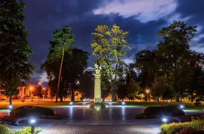 a monument in a park at night with lights at Marijampole Apartment with FREE Parking in Marijampolė