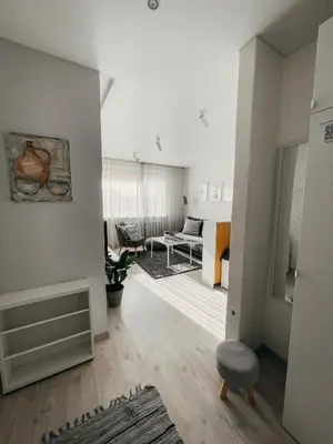 a living room with a couch and a chair at Marijampole Apartment with FREE Parking in Marijampolė